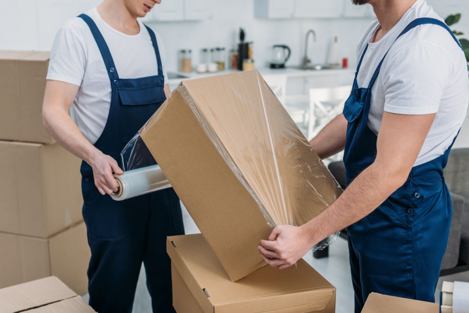 Local moving team packing boxes